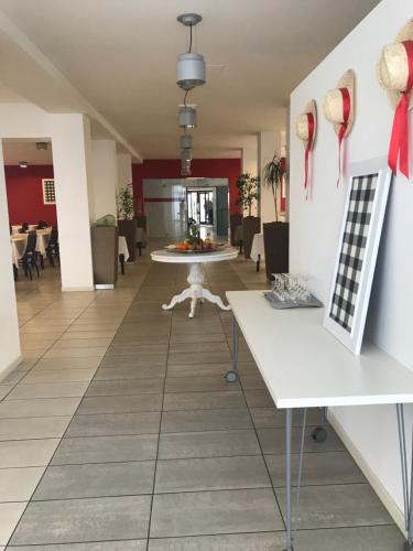 a hallway with a table and chairs in a building at Hotel Royal in San Benedetto del Tronto