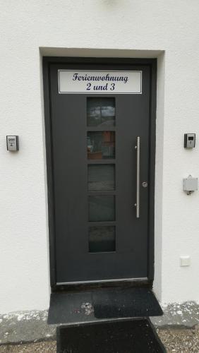 a black door with a sign on top of it at Ferienwohnungen Karwendelbahn in Mittenwald