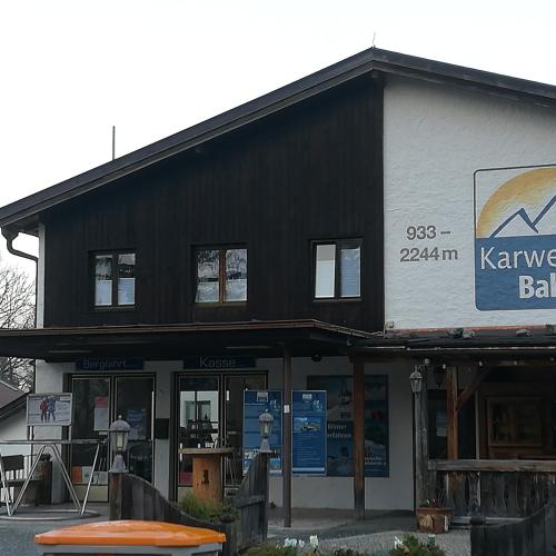 a black and white building with a surfboard in front of it at Ferienwohnungen Karwendelbahn in Mittenwald