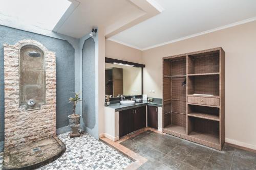 a bathroom with a sink and a shower at Dura Villas Bali at Kerobokan in Kerobokan