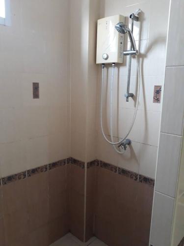 a shower in a bathroom with a shower at Uncle House Krabi in Krabi town