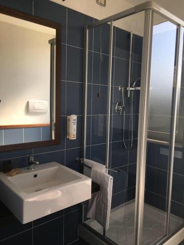 a bathroom with a sink and a shower at Hotel Royal in San Benedetto del Tronto