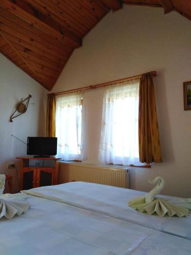 a bedroom with a bed with a swan on it at вила Здравец in Yagodina