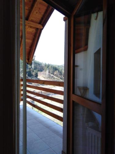 a view from a glass door of a porch at вила Здравец in Yagodina