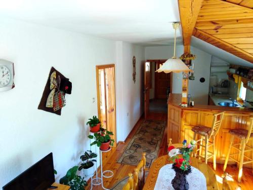 a living room with a table and a kitchen at вила Здравец in Yagodina