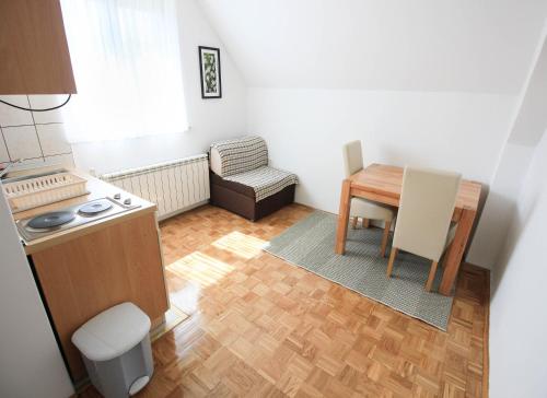 a small kitchen with a table and a table and chair at House Milan in Rastovača