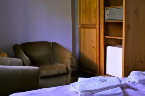 a living room with a couch and a chair at Penzion Nikola in Pec pod Sněžkou