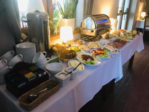 a table with a buffet of food on it at Pensjonat Bajdarka in Suraż