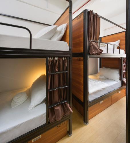 a room with bunk beds in a hostel at 7 Wonders Hostel at Upper Dickson in Singapore