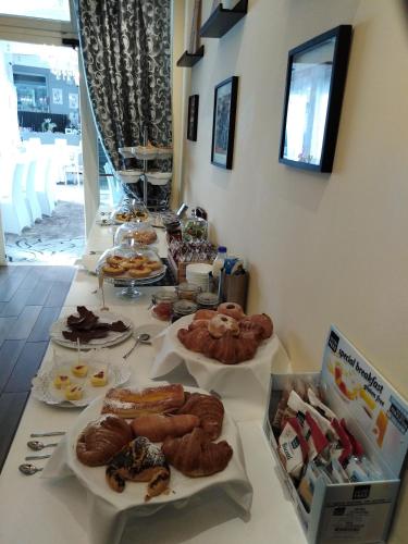 a table with different types of pastries on it at Hotel La Torraccia in Tarquinia