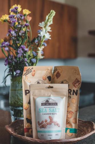 a plate with a bag of salami and a vase with flowers at Dura Villas Bali at Kerobokan in Kerobokan