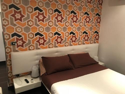 a bedroom with a bed with a wall at Impero 6 in Scauri