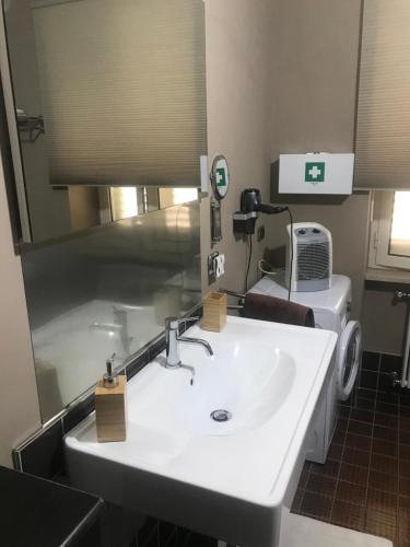 a bathroom with a white sink and a mirror at Impero 6 in Scauri
