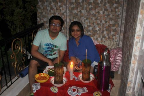 a man and a woman sitting at a table with a candle at Mansarover Home Stay in Kalimpong