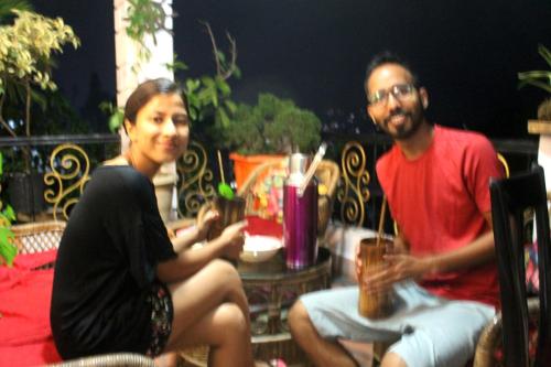 a man and a woman sitting on a patio at Mansarover Home Stay in Kalimpong