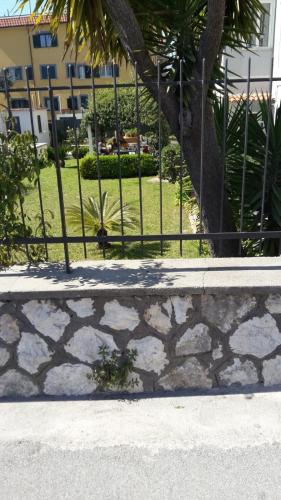a fence in front of a building with a yard at Impero 6 in Scauri