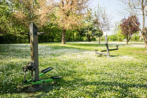 a park with two benches in a field of flowers at Best Western Modena District in Campogalliano