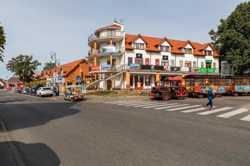 a street with a building and a tractor on the road at Krab in Rewal