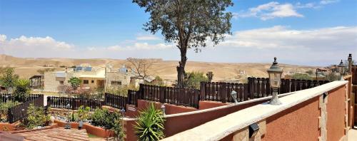 a balcony of a house with a view of the desert at Dead Sea Sun Guest House in Arad