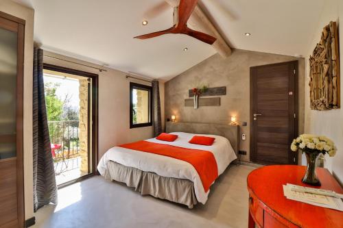a bedroom with a large bed and a window at Le Mas de la Lombarde in Lourmarin