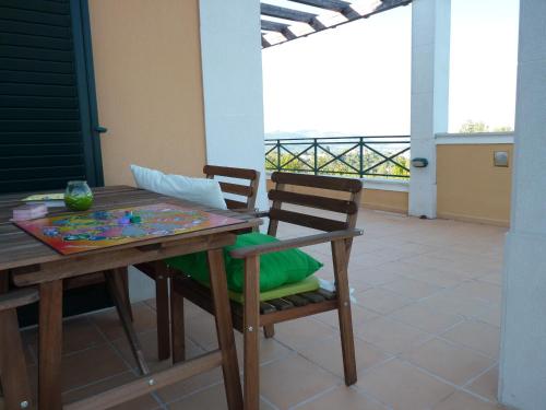 a table and chairs on a patio with a view at Casal das Oliveiras in Setúbal