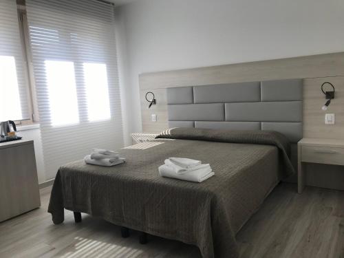 a bedroom with a bed with two towels on it at Il Sole e la Luna B&B in Garda in Garda