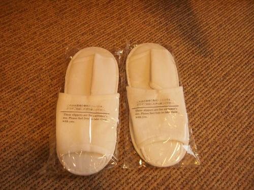 a pair of white shoes in a plastic bag at Nest Hotel Kumamoto in Kumamoto