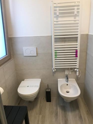 a small bathroom with a toilet and a sink at Il Sole e la Luna B&B in Garda in Garda