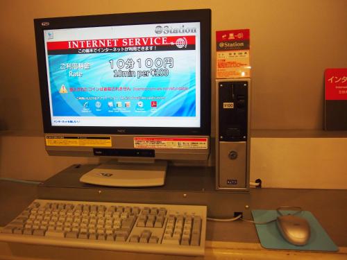 a computer monitor with a keyboard and a mouse at Nest Hotel Kumamoto in Kumamoto