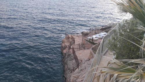 a view of the water from a cliff next to the ocean at Your Home Montenegro in Dobra Voda