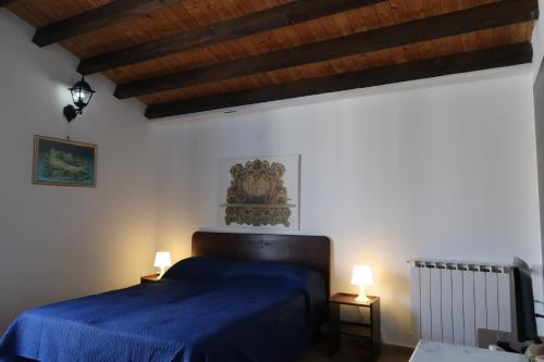 Säng eller sängar i ett rum på Baglio Costa Di Mandorla