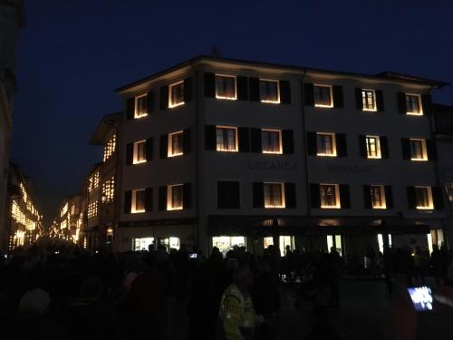 a group of people standing outside of a building at night at Locanda le Monache in Camaiore