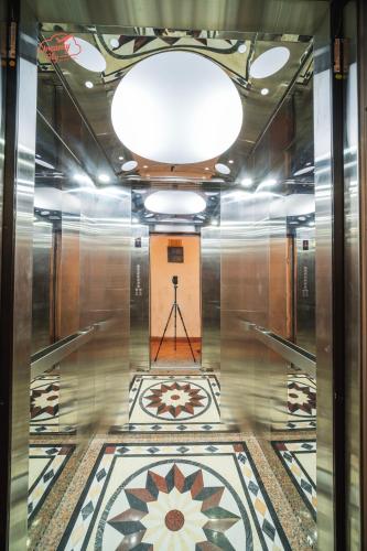 a hallway with a tile floor and a ceiling at Dreamy Sky - Airport View Boutique Hotel in Da Nang