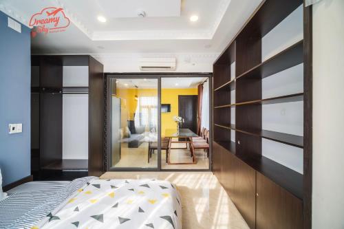 a bedroom with a bed and a dining room at Dreamy Sky - Airport View Boutique Hotel in Da Nang