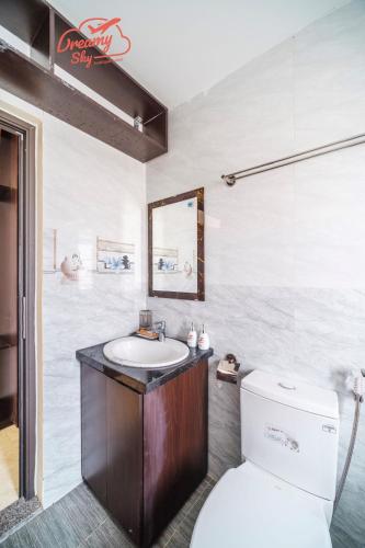 a bathroom with a toilet and a sink at Dreamy Sky - Airport View Boutique Hotel in Da Nang