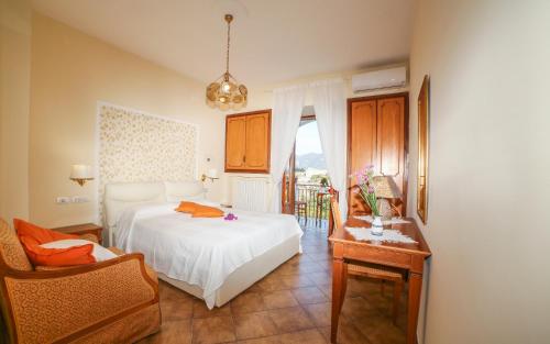 a bedroom with a bed and a chair and a table at Ravello View in Scala