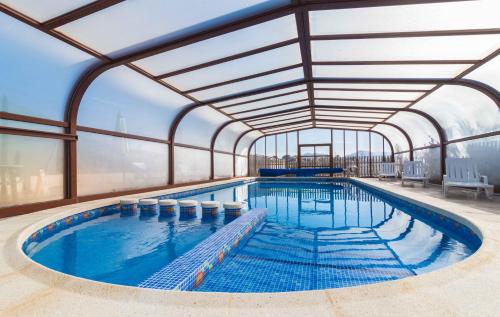 a large swimming pool with a glass ceiling at Casas Rurales El Viejo Establo in Fortuna