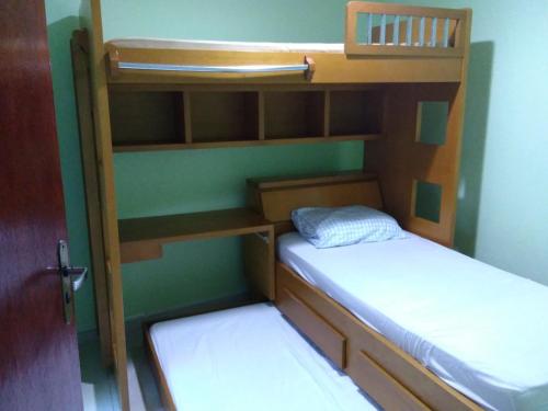 two bunk beds in a room with a door at Hospedagem da Val in Angra dos Reis