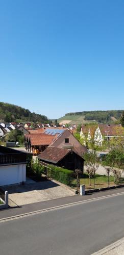 a view of a town with a building and a road at Weinbergblick in Ramsthal