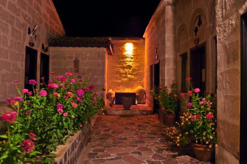 an alley with flowers and a tub in a building at Duru Hotel Cappadocia in Avanos