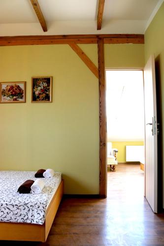 a bedroom with a bed and a large window at Pozingė Pegasas Pokylių namai in Klaipėda