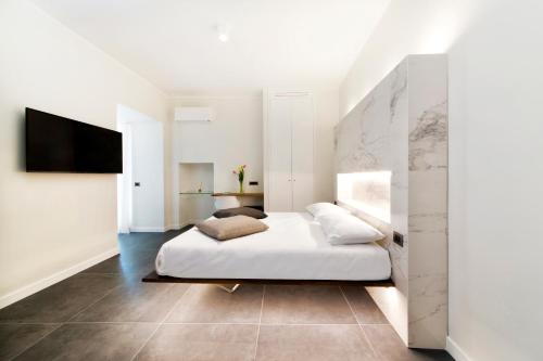 a bedroom with a bed and a tv on a wall at villa orleans in Amalfi