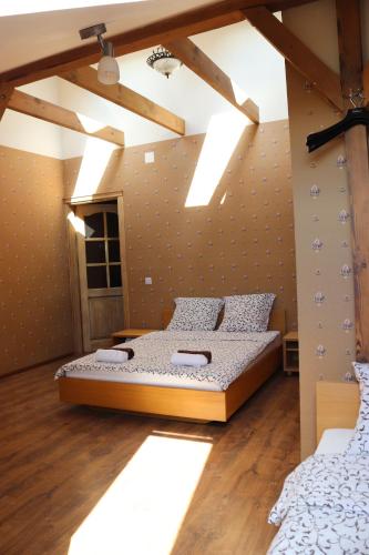 a bedroom with two beds and a ceiling with lights at Pozingė Pegasas Pokylių namai in Klaipėda