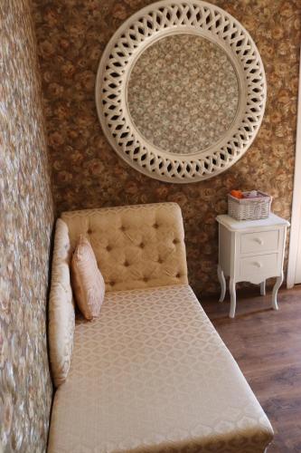 a room with a mirror and a couch and a table at Pozingė Pegasas Pokylių namai in Klaipėda