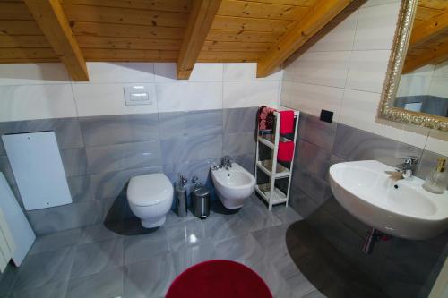 a bathroom with two sinks and a toilet at All'Antica Distilleria in Vimercate