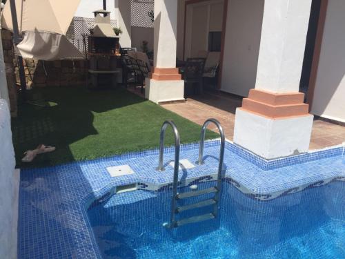 a swimming pool with a staircase in a house at Casa El Campanario in El Bosque
