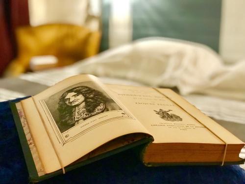 an open book sitting on top of a table at Hôtel Paul Riquet in Béziers