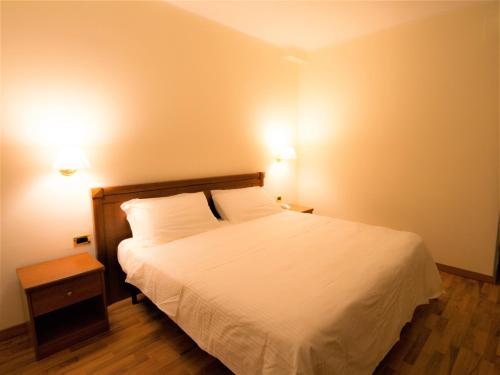 Ein Bett oder Betten in einem Zimmer der Unterkunft Hotel Santa Lucia