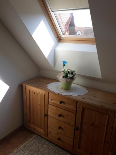 a room with a window and a dresser with a plant on it at Russhof-Fam.Thomann in Stainz