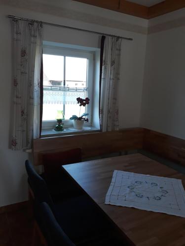 a dining room with a table and a window at Russhof-Fam.Thomann in Stainz